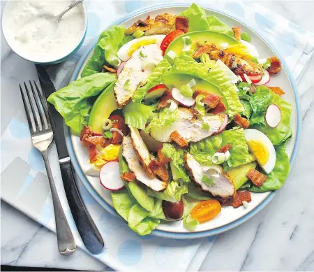  ??  ?? This Cobb salad is topped with in-season B.C. radishes and slices of grilled chicken, not the boiled, sliced meat used in the original.