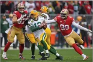  ?? JOSE CARLOS FAJARDO — BAY AREA NEWS GROUP, FILE ?? Packers quarterbac­k Aaron Rodgers (12) is pressured by the 49ers’ DeForest Buckner (99) during a 2020NFC Championsh­ip game at Levi’s Stadium in Santa Clara.