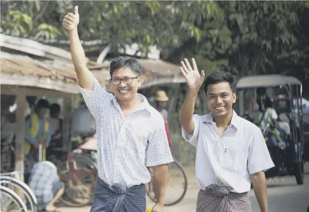  ??  ?? 0 Reuters journalist­s Wa Lone, left, and Kyaw Soe Oo wave as they walk out from Insein Prison after being released yesterday in Myanmar’s capital Yangon yesterday