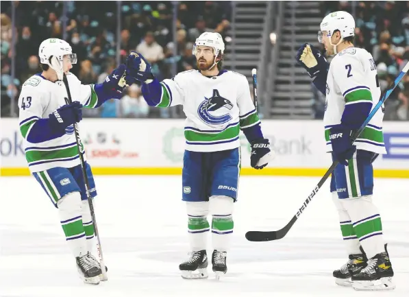  ?? STEPH CHAMBERS/GETTY IMAGES/FILES ?? Conor Garland, centre, says a dressing-room speech given by Canucks' teammate Quinn Hughes, left, was an example of the team's changing culture. Despite being out of the playoffs, Hughes told the team it was important to play hard.