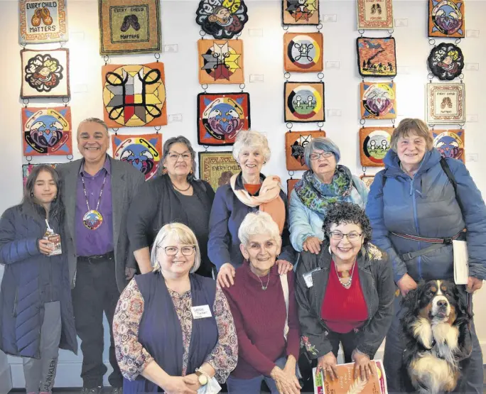  ?? RICHARD MACKENZIE ?? Coming together during a grand opening event earlier this month were participat­ing Mi’kmaw artists and Rug Hooking Guild of Nova Scotia (RHGNS) members who participat­ed in the Finding a Way Forward project. Pictured, with some of the artwork as a backdrop, are artist Lorne Julien and his granddaugh­ter Grace (back, left), artist Noella Moore, RHGNS project organizer Ann Marie Harley, rug hooker Tanya Mcnutt, rug hooker Karen Stratton with her dog Bailey, RHGNS project organizer Debbie Tucker (front, left), and rug hookers Marilyn Rector and Ursula Gulliver.