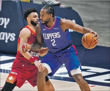 ?? NUGGETS GUARD David Zalubowski Associated Press ?? Jamal Murray, left, plays tight defense on Clippers forward Kawhi Leonard on Friday night. Leonard had 21 points, including a pair of threes, before exiting late after taking an elbow to the mouth.