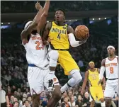  ?? ASSOCIATED PRESS FILE ?? Indiana’s Victor Oladipo (4) goes to the basket against the Knicks’ Mitchell Robinson (23) in February at Madison Square Garden. The Pacers will finish this season without Oladipo after the two-time All-Star decided to sit out because of the risk of re-injuring his right knee.