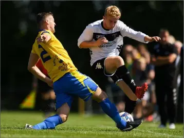  ??  ?? Newcomer Craig McCabe tackling Cillian Duffy of Maynooth Town.