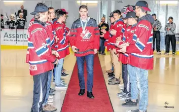  ?? GARY MANNING ?? Members of the midget Wildcats line the red carpet and clap as Drake Batherson heads out to centre ice to drop the first puck at the junior A game Jan. 7.