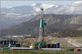  ?? DAVID ZALUBOWSKI — THE ASSOCIATED PRESS ?? A natural gas well pad sits in front of the Roan Plateau near the Colorado mountain community of Rifle, Colo. Federal officials sold oil and natural gas leases on nearly 55,000 acres of federal land on the Roan Plateau but developmen­t will not occur...