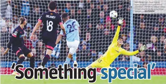  ?? – REUTERSPIX ?? Manchester City’s Riyad Mahrez scores his team’s third goal during yesterday’s Champions League Group G match against Sevilla at the Etihad Stadium .