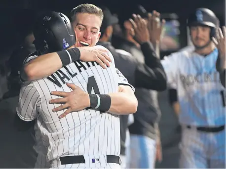  ?? Andy Cross, The Denver Post ?? Rockies pinch hitter Pat Valaika celebrates with second baseman Ryan McMahon after hitting a two-run home run against Los Angeles Dodgers starting pitcher Hyun-Jin Ryu in the fifth inning Friday night at Coors Field.