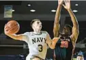  ?? TERRANCE WILLIAMS/AP ?? Navy guard Sean Yoder, left, goes to the basket against Princeton forward Keeshawn Kellman to attempt a layup during the second half of Friday night’s game in the Veterans Classic in Annapolis.