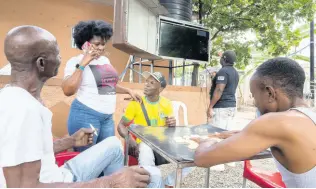  ?? ?? Patrons gather Sunday at a section of Sonia’s Place on the Terrace, a popular bar on Waltham Park Road in St Andrew, to view the opening match of the 2022 World Cup between Qatar and Ecuador. The South Americans won 2-0.