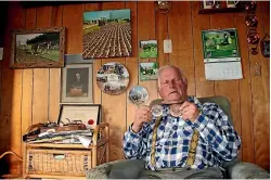  ?? ROB TIPA/STUFF ?? John Thornton, a three-time winner of the New Zealand Silver Plough Championsh­ip, holds two bronze medals he won at the World Ploughing Championsh­ips in Holland and Germany in the late 1970s.