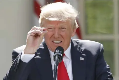  ?? Photo: REUTERS ?? U.S. President Donald Trump refers to amounts of temperatur­e change as he announces his decision that the United States will withdraw from the landmark Paris Climate Agreement, in the Rose Garden of the White House in Washington, US on June 1, 2017.