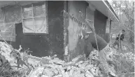  ?? Associated Press ?? ■ In this Nov. 6, 2011 file photo, Chad Devereaux examines bricks that fell from three sides of his inlaws home in Sparks, Okla., after two earthquake­s hit the area in less than 24 hours.