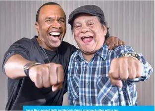  ??  ?? Sugar Ray Leonard (left) and Roberto Duran greet each other with a hug.