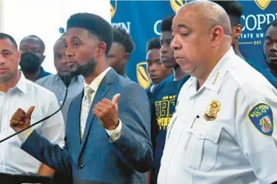  ?? KARL MERTON FERRON/BALTIMORE SUN ?? Baltimore Mayor Brandon Scott speaks along with Police Commission­er Michael Harrison during a news conference before a meeting with civic and business leaders on Thursday at Coppin State University. Several squeegee workers joined them during the news conference and for the meeting.