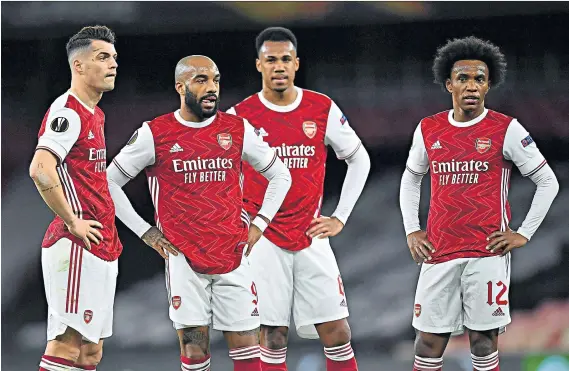  ??  ?? Dramatic finale: Arsenal’s players and Mikel Arteta (below) appear dumbstruck