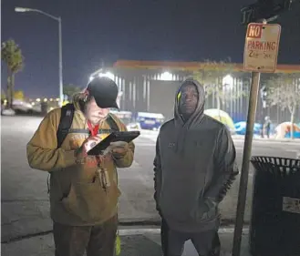  ?? NELVIN C. CEPEDA U-T ?? Volunteer Miguel Figueroa gets informatio­n from a homeless person in the East Village on Jan. 26.