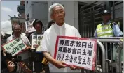  ?? KIN CHEUNG — THE ASSOCIATED PRESS FILE ?? Hong Kong's outspoken cardinal Joseph Zen, center, and other religious protesters hold placards with “Respects religious freedom” written on them during a demonstrat­ion outside the China Liaison Office in Hong Kong.