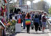  ??  ?? Strolling...people enjoying their freedom in Kingston upon Thames, Surrey, yesterday