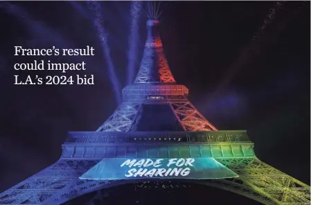  ?? PATRICK KOVARIK, AFP/GETTY IMAGES ?? The Eiffel Tower was illuminate­d in February with the colors of the Olympic flag and Paris’ 2024 Olympic bid slogan.