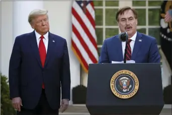  ?? ALEX BRANDON — THE ASSOCIATED PRESS FILE ?? In this March 30, 2020 file photo, My Pillow CEO Mike Lindell speaks as President Donald Trump listens during a briefing about the coronaviru­s in the Rose Garden of the White House, in Washington. Lindell, is weighing a run for governor in Minnesota. If he follows through on a campaign, it could be an early test of where the Republican Party is headed in the post-Donald Trump era.