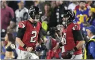  ?? MARK J. TERRILL — THE ASSOCIATED PRESS ?? Falcons quarterbac­k Matt Ryan, left, celebrates with backup quarterbac­k Matt Schaub after the throwing a touchdown pass Saturday against the Rams.