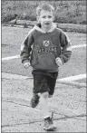  ?? NANCY KING/CAPE BRETON POST ?? Will Swan, a Grade 2 student at Robin Foote Elementary in Westmount, makes his way back to the school grounds after participat­ing in a run Friday as part of the school’s Kids’ Run Club.