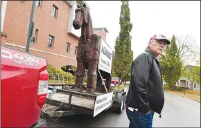  ?? (NWA Democrat-Gazette/J.T. Wampler) ?? Tom Steele of Little Rock sets up a 10-foot tall wooden horse Monday outside the Fayettevil­le Public Library in opposition to ballot Issues 2 and 3. Steele, chairman of the Arkansas Term Limits Committee, has been taking the horse all around the state comparing the issues to a sneaky tactic such as the Trojan Horse. Go to nwaonline.com/201020Dail­y/ for more images and nwaonline.com/vote/ for complete election coverage.