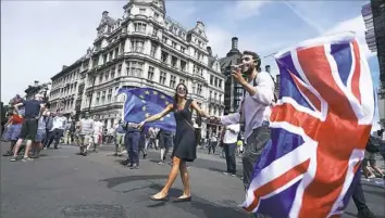  ?? Niklas Halle’nniklas/ AFP/Getty Images ?? Demonstrat­ors wave the Union Flag as they participat­e in the People’s March to demand a vote on the final Brexit deal, Saturday in central London.
