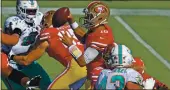  ?? JOSE CARLOS FAJARDO — BAY AREA NEWS GROUP ?? 49ers quarterbac­k Jimmy Garoppolo is pressured while attempting to pass against the Dolphins at Levi’s Stadium in Santa Clara on Sunday.