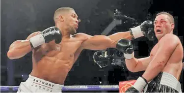 ?? Photo: BBC ?? From left Anthony Joshua connects his jab on Joseph Parker in their world heavyweigh­t unificatio­n fight at the Principali­ty Stadium in Cardiff, Wales on April 1, 2018.