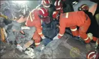  ?? LUO GUANGLIAN / FOR CHINA DAILY ?? A man is pulled out of the rubble of the landslide in Xuyong, Sichuan province, on Monday.