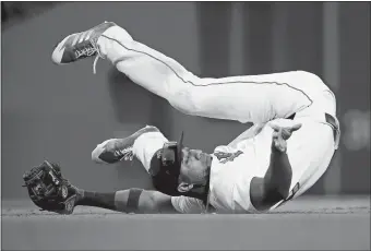  ?? MICHAEL DWYER/AP PHOTO ?? Red Sox second baseman Eduardo Nunez falls on his back while fielding the cut off throw on an RBI double by Jesus Sucre of the Rays in the eighth inning of Saturday’s game at Boston.