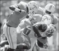  ?? AP/WADE PAYNE ?? (left) strips the ball from Western Kentucky running back Keshawn Simpson during Saturday’s game in Knoxville, Tenn.