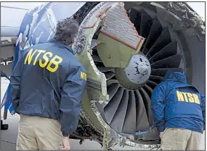  ?? AP ?? In this photo provided by the National Transporta­tion Safety Board, investigat­ors examine a Southwest Airlines plane engine last week that blew apart in midair.