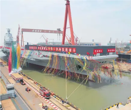  ?? Photos / AP ?? China has launched its third aircraft carrier, the first such ship to be both designed and built entirely within the country.