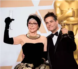  ??  ?? Moreno and Sebastian Lelio, winner of the Oscar for Best Foreign Language Film of the Year, pose backstage during the live broadcast of The 90th Academy Awards in Hollywood. — IC