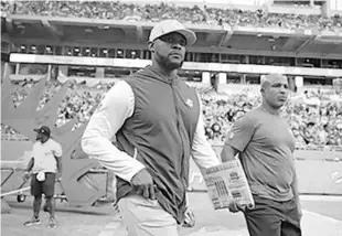  ?? JOHN MCCALL/SOUTH FLORIDA SUN SENTINEL ?? Miami Dolphins coach Brian Flores takes the field for his game against the New York Giants at Hard Rock Stadium on Dec. 5, 2021 in Miami Gardens.