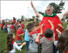  ?? NEWS-SENTINEL FILE PHOTOGRAPH ?? Then-Galt Councilman Thomas Malson gets swarmed by first graders from Fairsite Elementary School as they try to remove all of the strawberry’s black dots at the Veterans Field in Galt in May 2006. Malson found himself part of the Galt City Council...