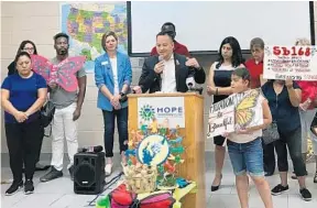  ?? LISA MARIA GARZA/ORLANDO SENTINEL ?? State Rep. Carlos Guillermo Smith, D-Orlando, speaks Tuesday at a news conference held by Florida immigrant rights groups to announce a federal lawsuit against the state’s “sanctuary cities” ban. At right is state Rep. Anna Eskamani, D-Orlando.