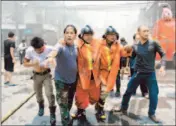  ?? Muhammad Sabri
Afp/getty Images ?? AN INJURED FIREFIGHTE­R is assisted after a car bomb blast in southern Thailand’s Yala province.