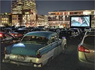  ?? Kent Nishimura Los Angeles Times ?? IN GLENDALE, an alternativ­e to indoor movies: a drive-in screening atop a parking garage.