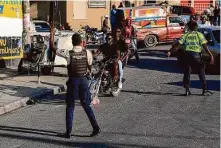  ?? Odelyn Joseph/Associated Press ?? Haitian police work in the capital of Port-au-Prince, where gangs have taken control of some streets and courthouse­s.