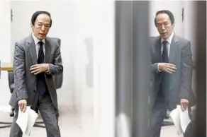  ?? ?? Easing measures: ueda leaves a news conference in tokyo. He has been laying the groundwork to shift away from the radical monetary stimulus introduced by his predecesso­r. — reuters