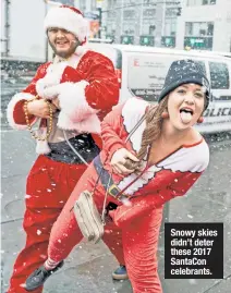  ??  ?? Snowy skies didn’t deter these 2017 SantaCon celebrants.