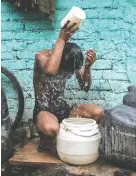  ?? XAVIER GALIANA/AFP VIA GETTY IMAGES ?? A boy bathes during a sweltering day in New Delhi, India, as heat in that country hits new highs.