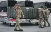  ?? Efrem Lukatsky Associated Press ?? UKRAINIAN troops unload military aid. The U.S. has committed more than $40 billion to Ukraine.