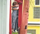  ?? Carlos Giusti / Associated Press ?? Residents in Old San Juan comfort each other as the community recovers from Hurricane Maria on Monday.