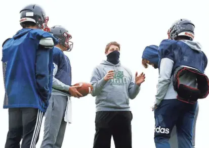  ?? FRED SQUILLANTE/COLUMBUS DISPATCH ?? Hartley senior offensive lineman Jake Skelly, center, was sidelined by leukemia but regularly attends practice. He has committed to Ohio University.