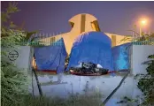  ?? — PTI ?? A Delhi Metro train is seen covered under a blue plastic sheet after it crashed into the wall of its depot at Kalindi Kunj on Tuesday.